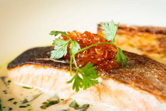 Close-up of Clare Island salmon crispy skin with salmon caviar and chervil at Marco Pierre White Steakhouse Dublin 2