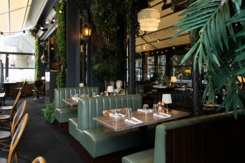 Covered terrace with green leather banquette seating at Marco Pierre White Steakhouse & Grill, Dawson Street Dublin 2
