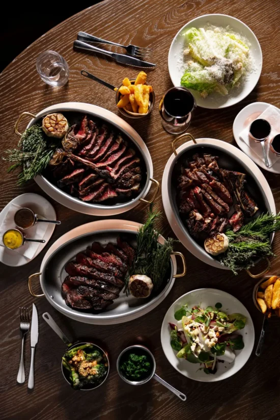 Three Côte de Boeuf sharing platters with sides for a group dinner at Marco Pierre White Steakhouse & Grill Dublin 2